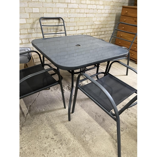 210 - A modern light weight glass and metal framed garden table together with four matching chairs and all... 