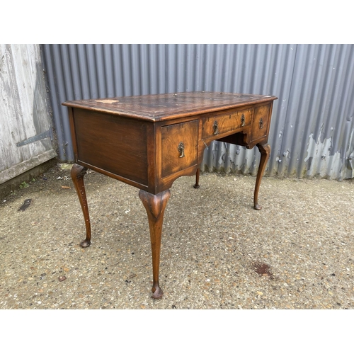 211 - A queen anne style three drawer writing table