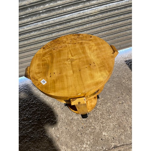 213 - A birds eye maple effect deco style occasional table 59 diameter