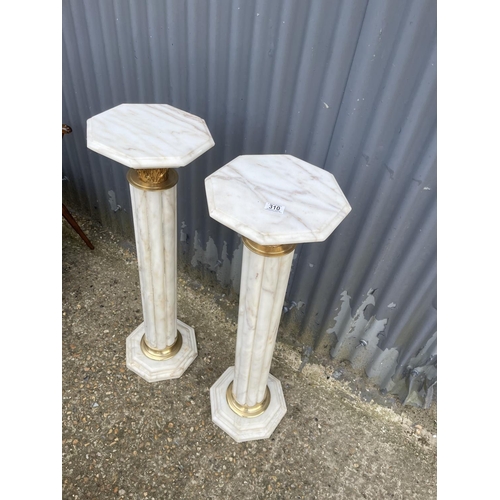 214 - A pair of white marble and gold gilt columns 100cm tall