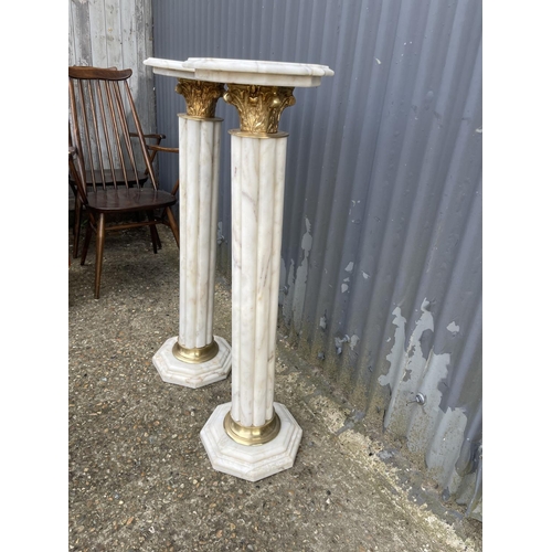 214 - A pair of white marble and gold gilt columns 100cm tall