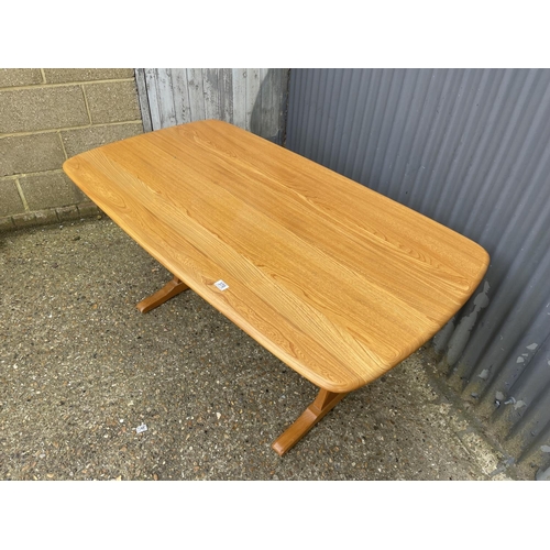 217 - An Ercol light elm refectory dining table 154x84x77