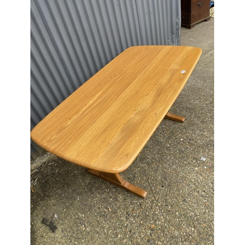 217 - An Ercol light elm refectory dining table 154x84x77