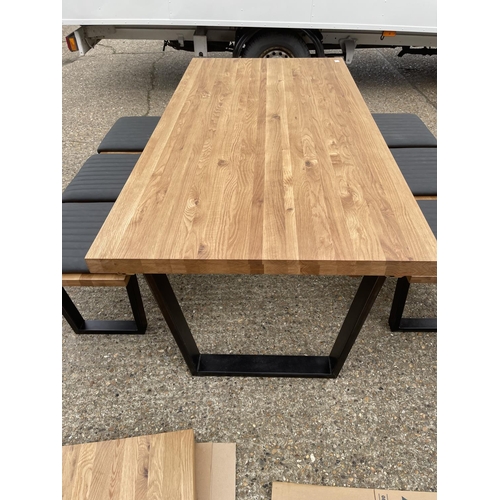 10 - A modern light oak refectory style dining table together with two bench seats with pads plus two ext... 