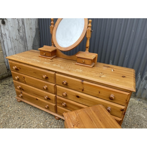 115 - A pine lowboy chest of 8 drawers together with swing mirror and matching bedside