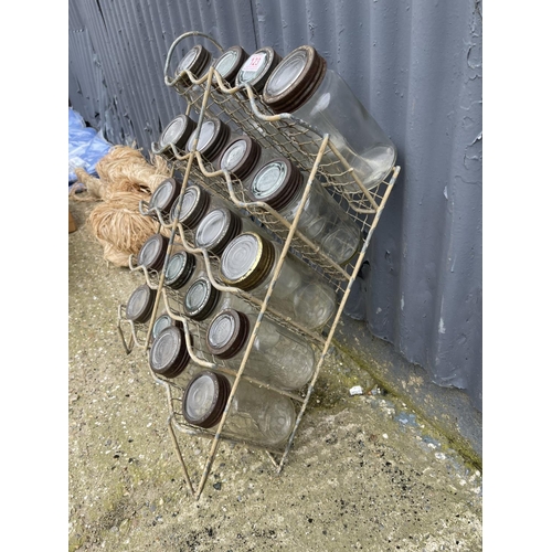 123 - A vintage metalwork jar rack loaded with original glass Kilmer jars