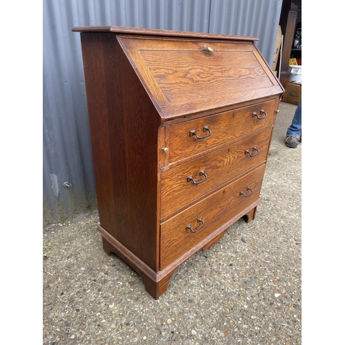 138 - An arts and crafts oak bureau with fitted interior