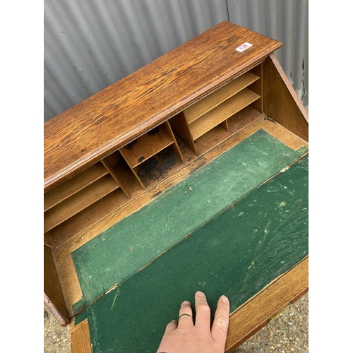 138 - An arts and crafts oak bureau with fitted interior