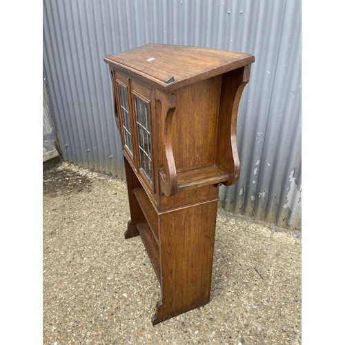 139 - An arts and crafts oak bookcase with leaded glass doors 93x30x120