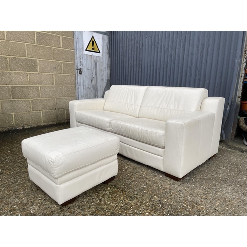 14 - A modern white leather sofa together with matching ottoman footstool