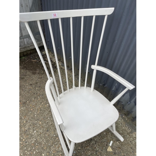 140 - A danish style white painted stick back rocking chair