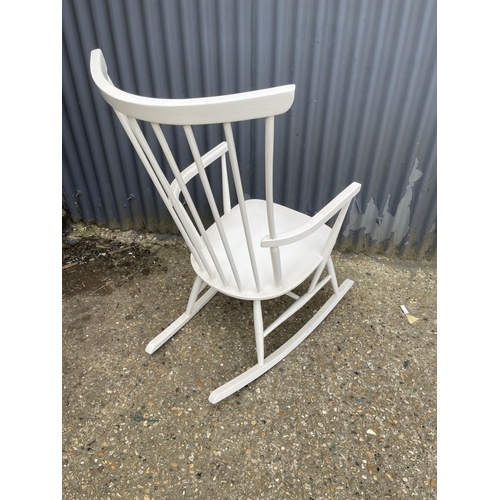 140 - A danish style white painted stick back rocking chair