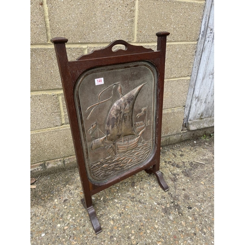 144 - An oak framed fire guard with copper panel