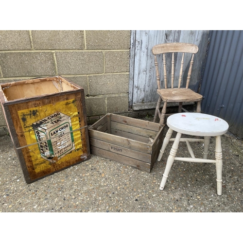 145 - A tea chest, fruit crate, painted chair and a stool