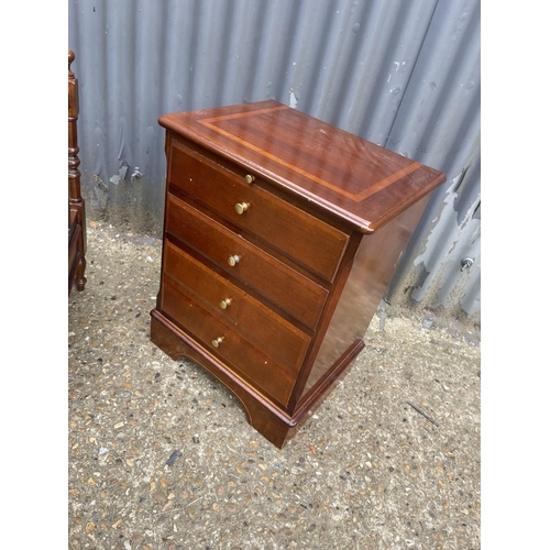 152 - A reproduction Canterbury book rack together with a repro chest of four