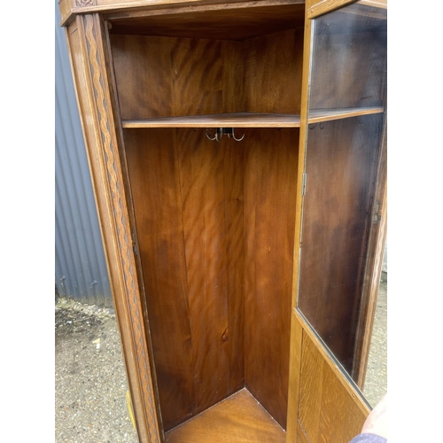 164 - An early 20th century oak corner wardrobe