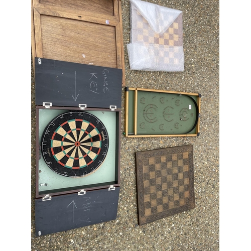 167 - Three chess board, darts board, oak wall cupboard and shove half penny