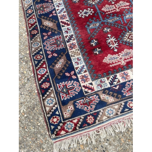 184 - A large red and blue pattern rug 295 x 200