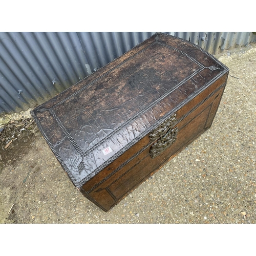 187 - A vintage domed top trunk, leather covered with brass stud work and iron handles 99x56 x 60