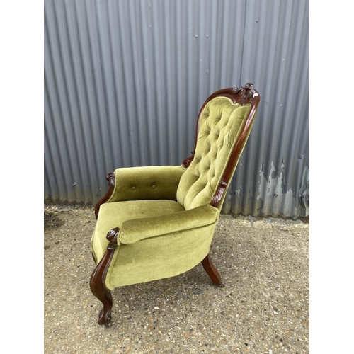 22 - A victorian green upholstered button back nursing chair