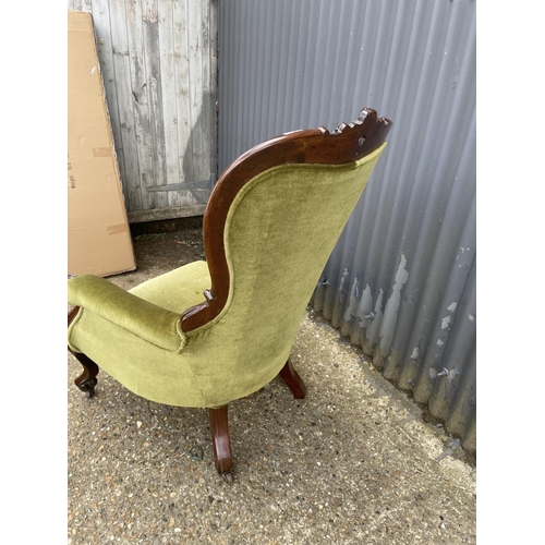 22 - A victorian green upholstered button back nursing chair