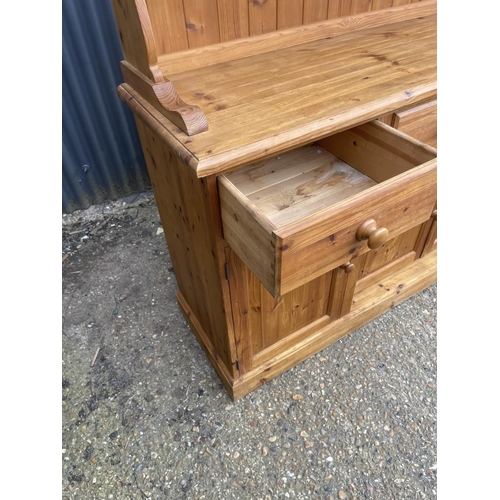 235 - A large solid far,house style pine four drawer dresser with glazed plate rack top 184x46x190