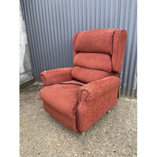 237 - A red upholstered electric rise and recline armchair