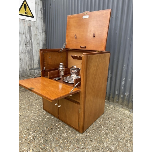 238 - A teak cased ships captains drinks cabinet with tray, bucket, shaker and hip flask. Fitted with plaq... 