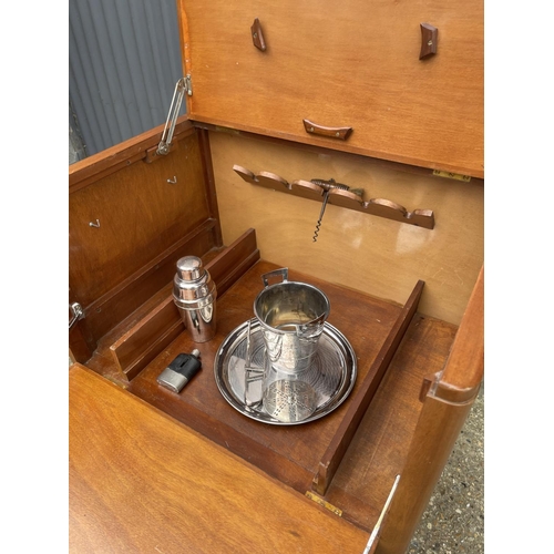 238 - A teak cased ships captains drinks cabinet with tray, bucket, shaker and hip flask. Fitted with plaq... 