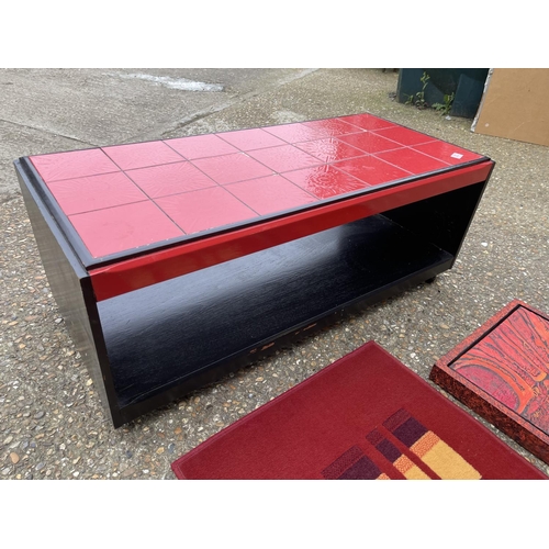 252 - A retro red pattern coffee table, red wall art and red rug