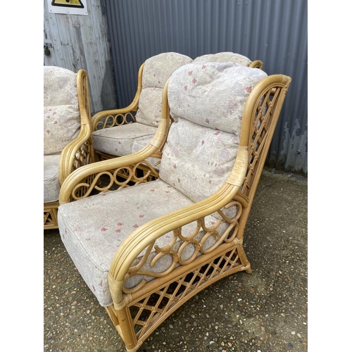 263 - A bamboo and wicker three piece conservatory suite consisting of two seater sofa and two chairs