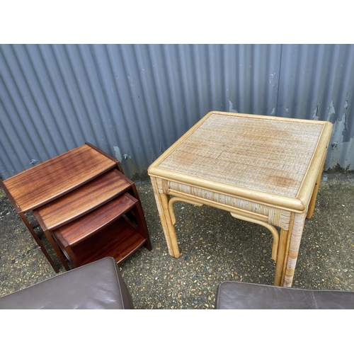 264 - A bamboo table, nest of three and two leather footstools