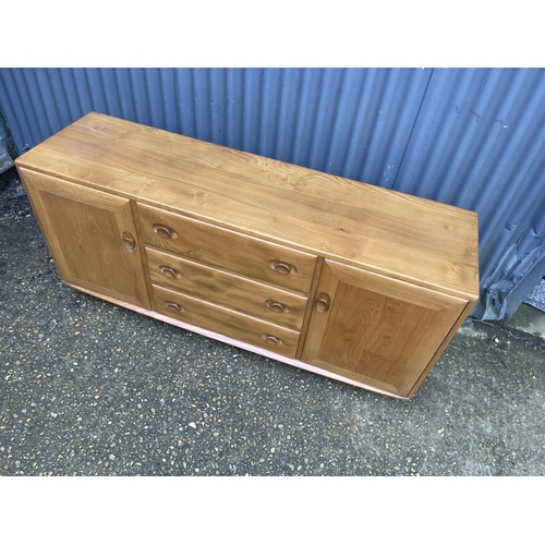 267 - An Ercol light elm three drawer and two door sideboard