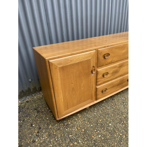 267 - An Ercol light elm three drawer and two door sideboard