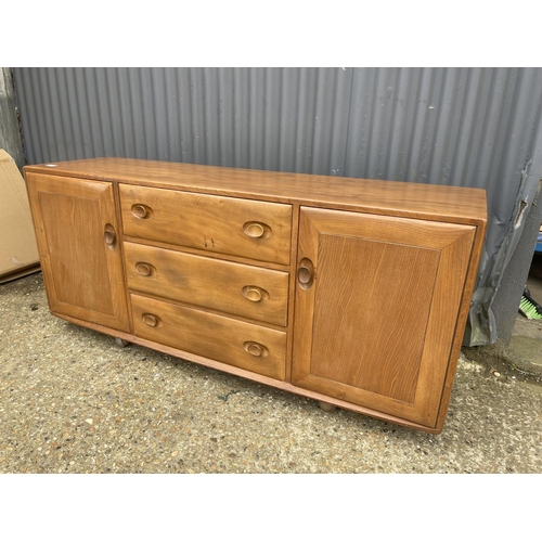 27 - An ercol light elm three drawer sideboard 158x44x70