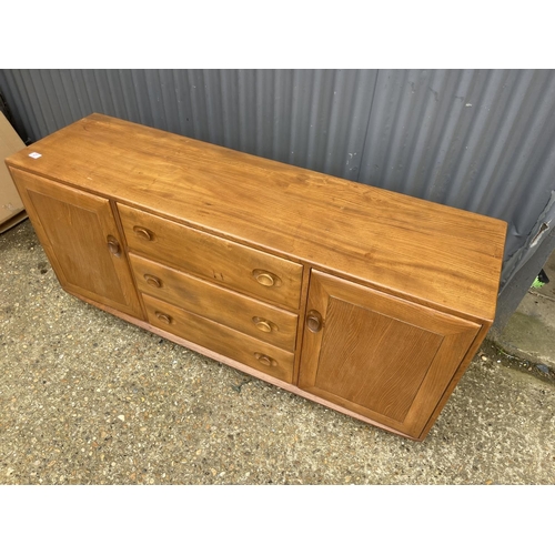 27 - An ercol light elm three drawer sideboard 158x44x70