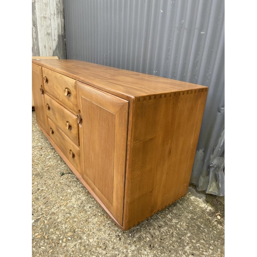 27 - An ercol light elm three drawer sideboard 158x44x70