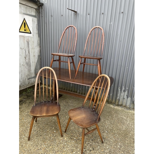 3 - An ercol elm refectory style table together with four stick back chairs