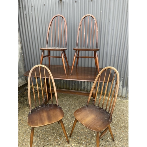 3 - An ercol elm refectory style table together with four stick back chairs