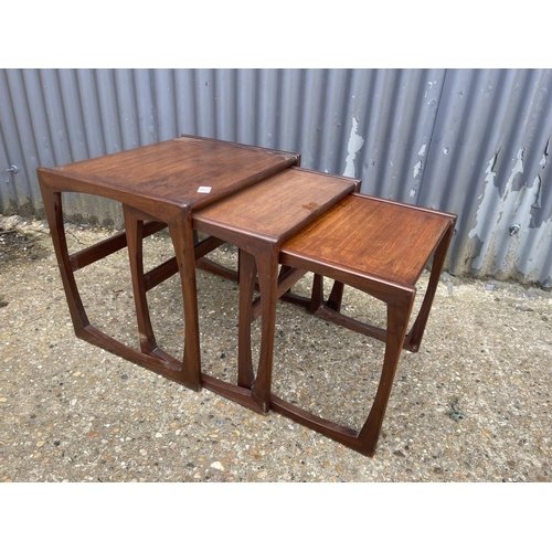 31 - A mid century teak nest of three