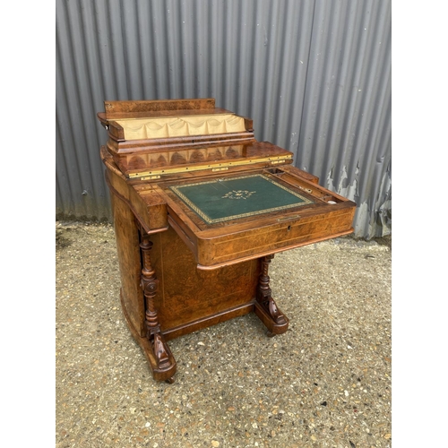 33 - A victorian walnut davenport desk with sliding writing surface and stationary rack top. Doors to eac... 