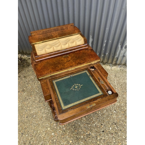 33 - A victorian walnut davenport desk with sliding writing surface and stationary rack top. Doors to eac... 