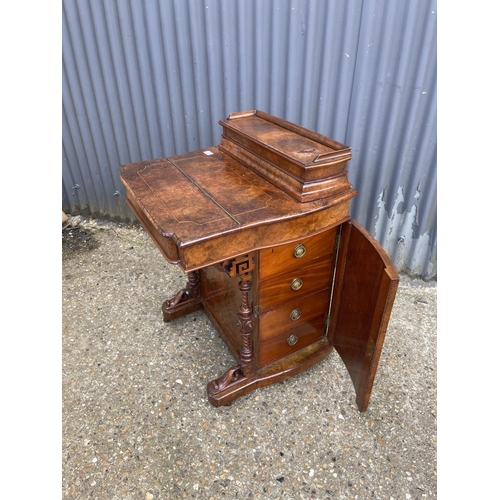 33 - A victorian walnut davenport desk with sliding writing surface and stationary rack top. Doors to eac... 