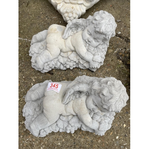 345 - Two cast concrete cherubs lying on grapes