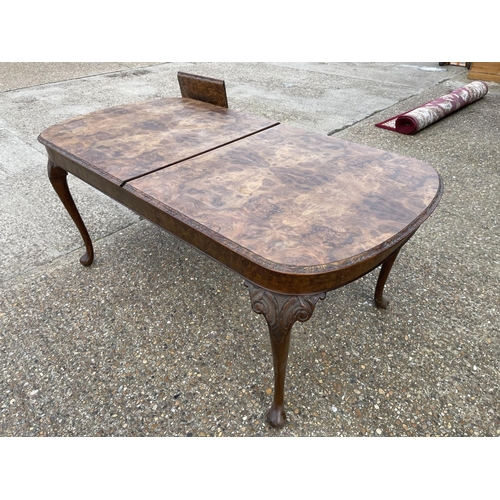 35 - A Queen Anne style walnut extending dining table with extension leaf