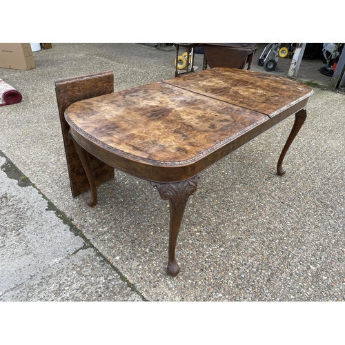 35 - A Queen Anne style walnut extending dining table with extension leaf