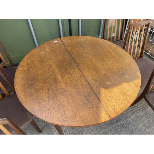 375 - A g plan circular teak extending dining table together with a set of six g plan dining chairs