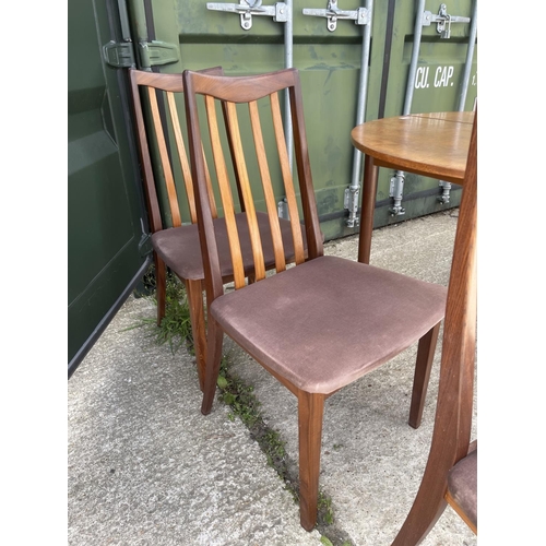 375 - A g plan circular teak extending dining table together with a set of six g plan dining chairs