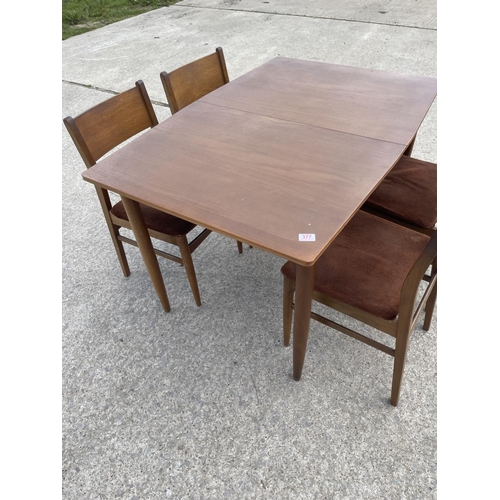 377 - a rectangular teak extending dining table together with four chairs