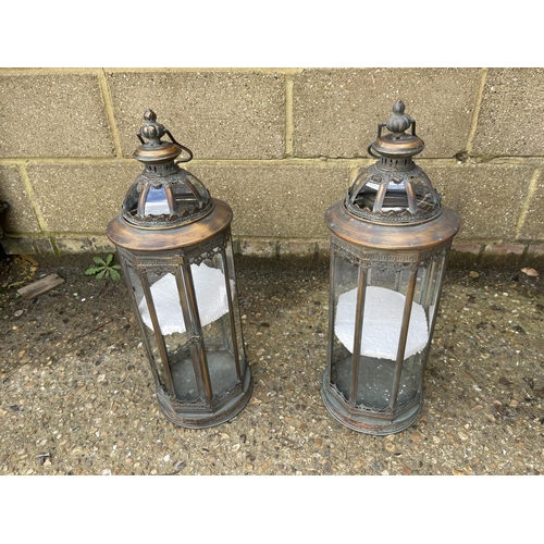 42 - A pair of copper and glass candle lanterns 61cm tall